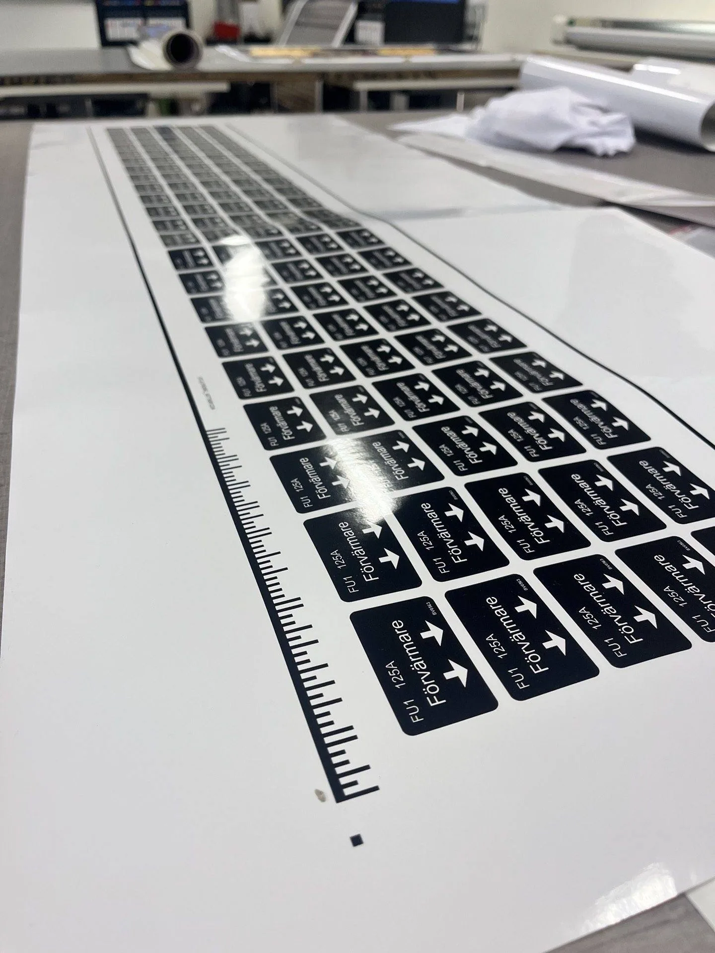 A close-up view of a printed keyboard layout with various labels and directional arrows, placed on a flat surface.